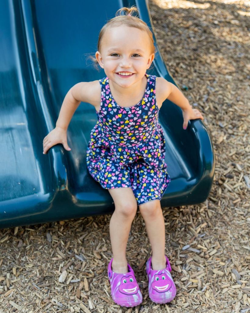 Girl smiling on a slide
