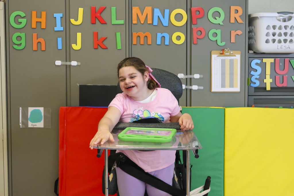 Smiling student in a stander.