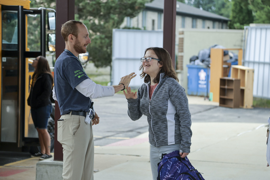Teacher high-fiving his student. 