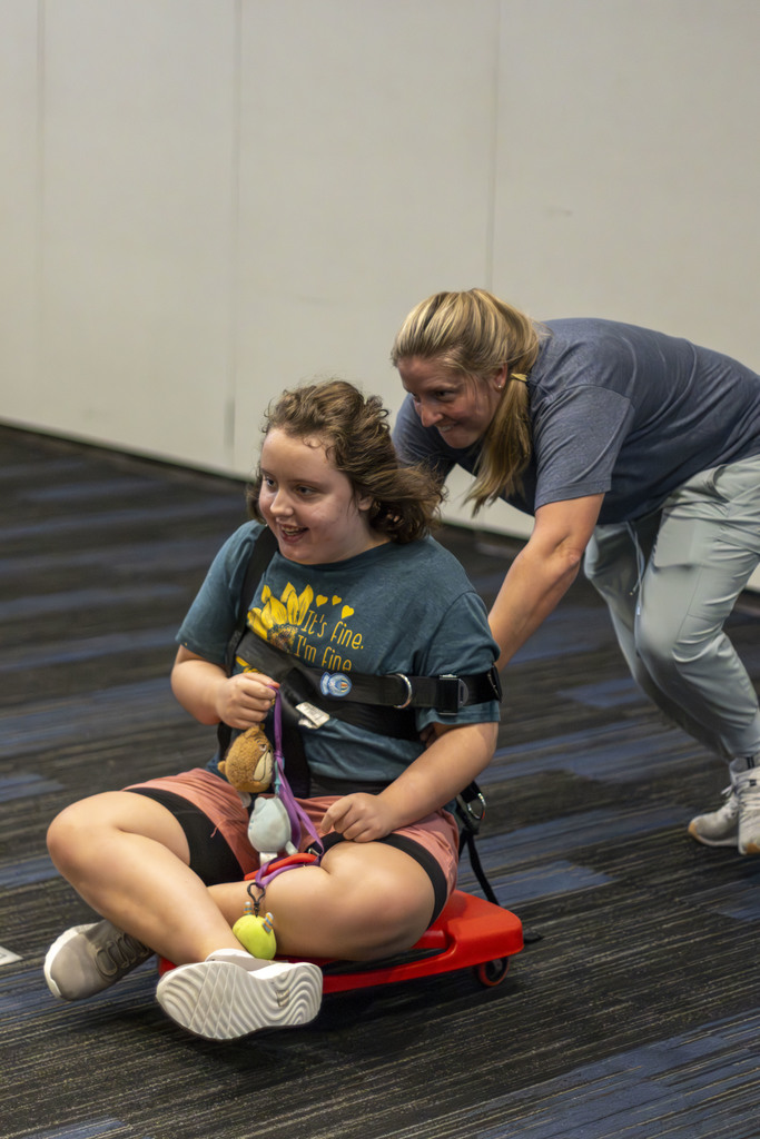 Smiling girl on a scooter