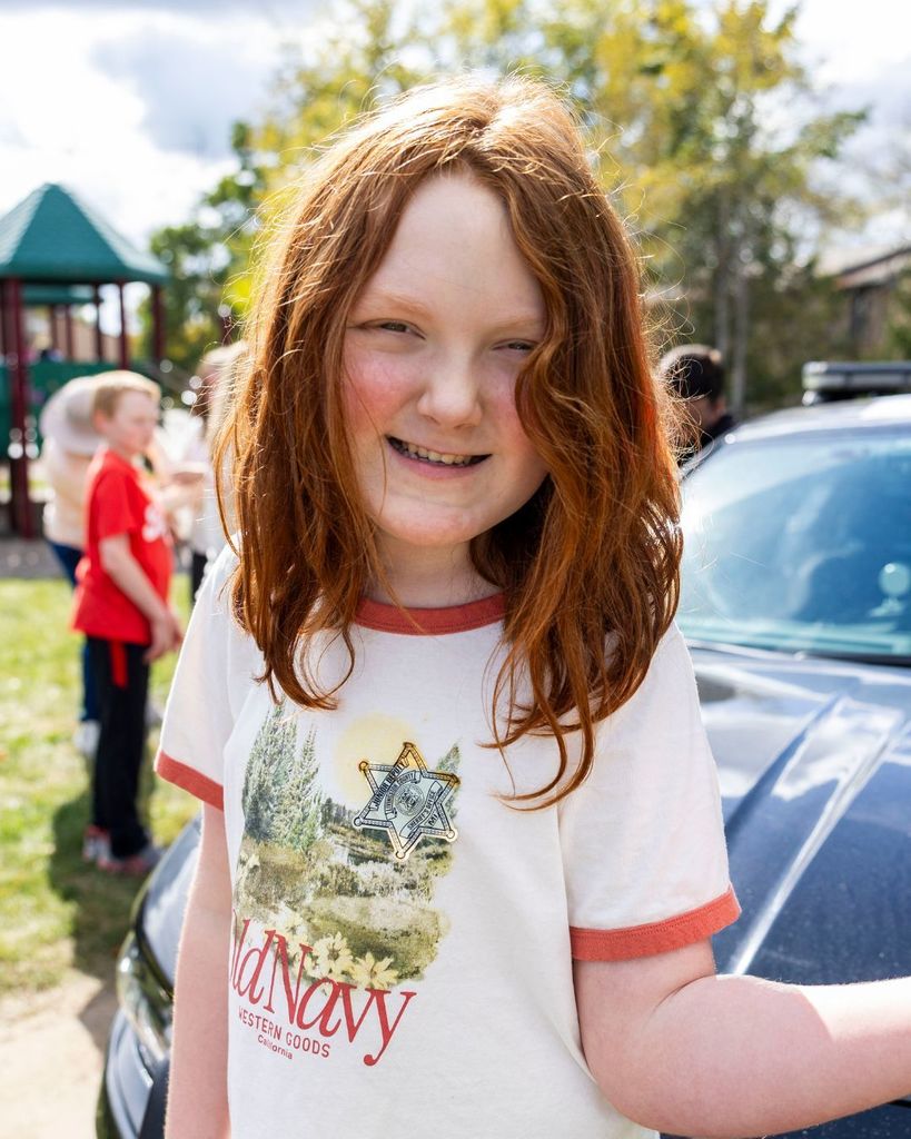 Student wearing sheriff badge stickers.