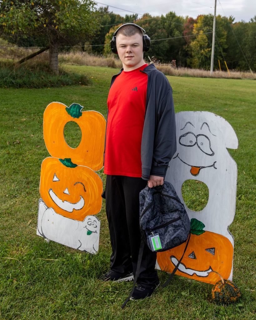 Boy posing in front of halloween signs