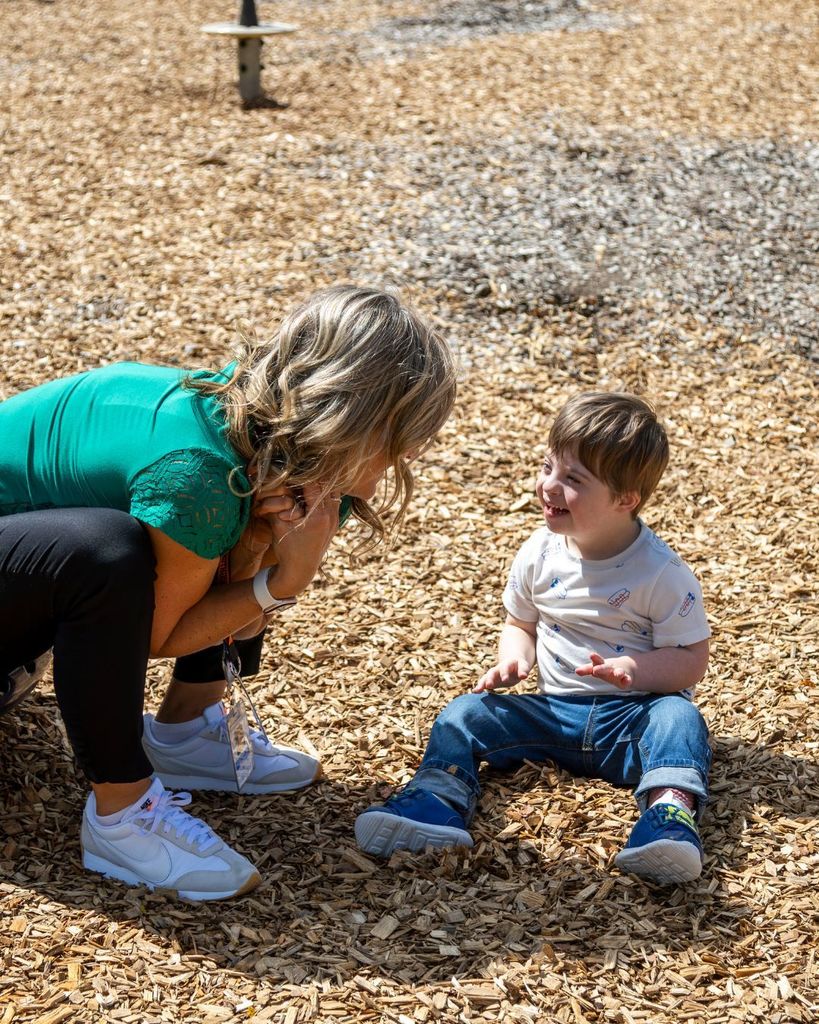 Child laughing with teacher