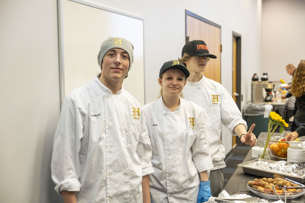 Kids serving food to adults. 