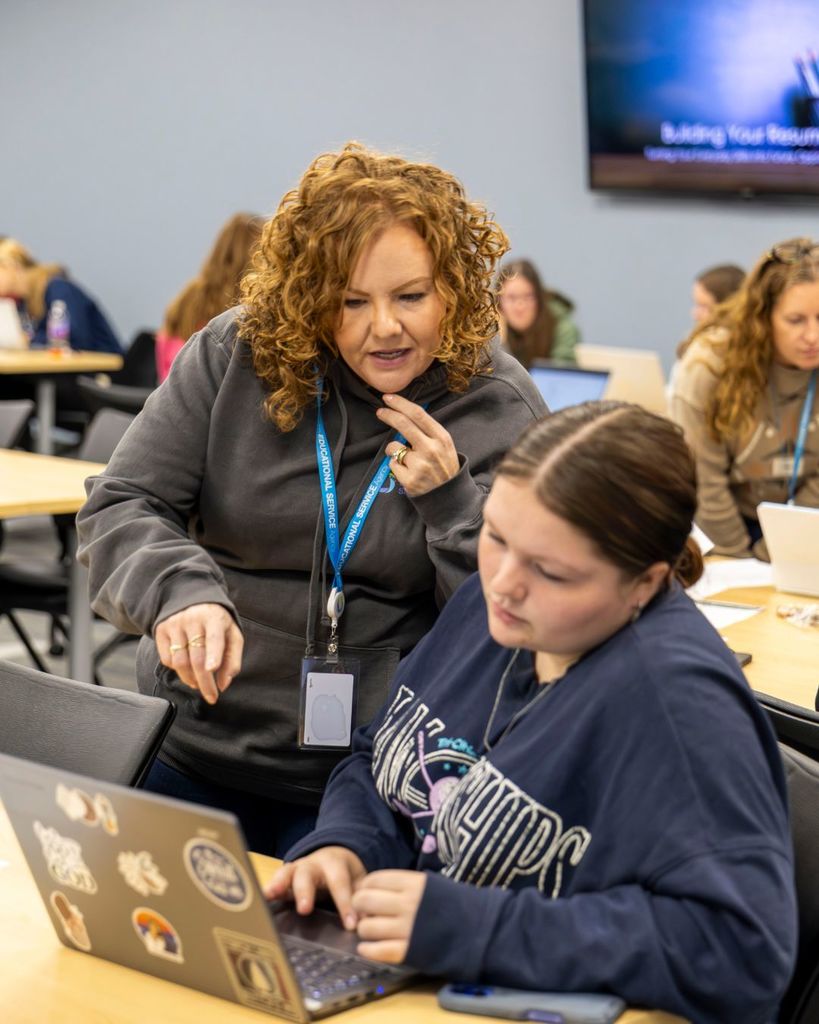 Adult helping student