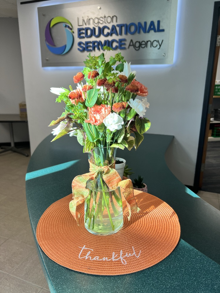 Holiday Flowers in front of LESA sign at Education Center