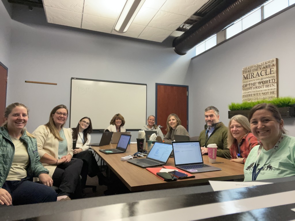 Pathway staff sitting around a conference room table. There are 9 people.