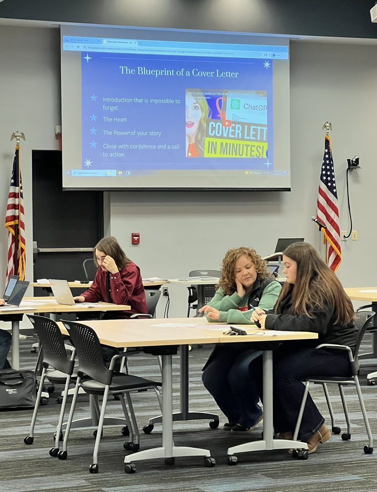 Teacher and student student sitting at table