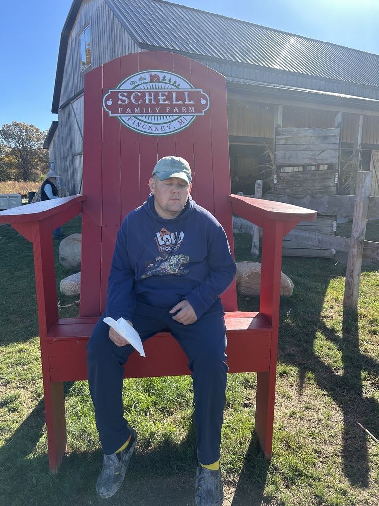 Student sitting in a big red chair