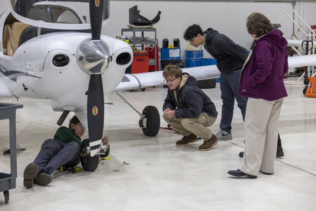 Students explore the mechanics of a plane at Crosswinds Aviation
