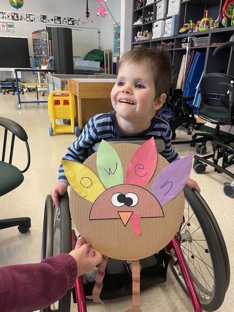 Student with their craft- turkey with feathers having letters of their name.