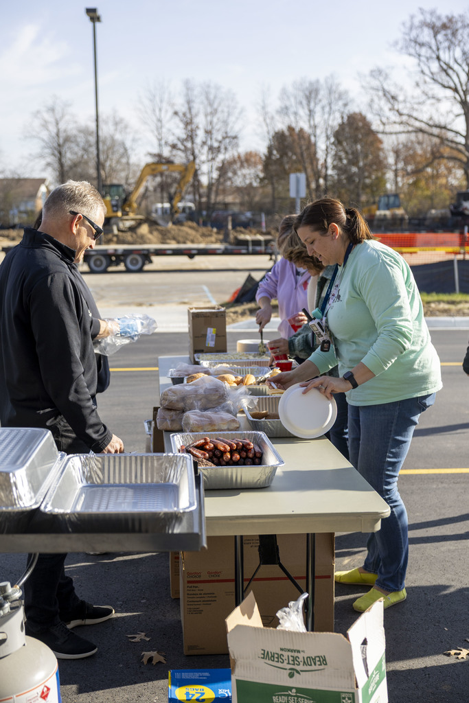 Women gather meals for her staff who couldn't make it outside.