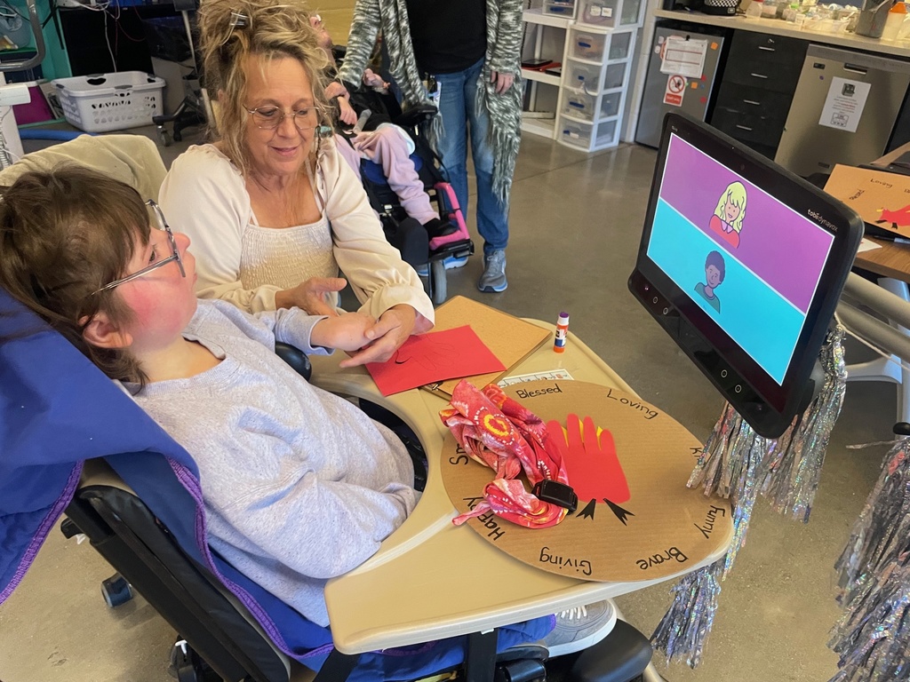 Teacher and assistant  with craft on the table.