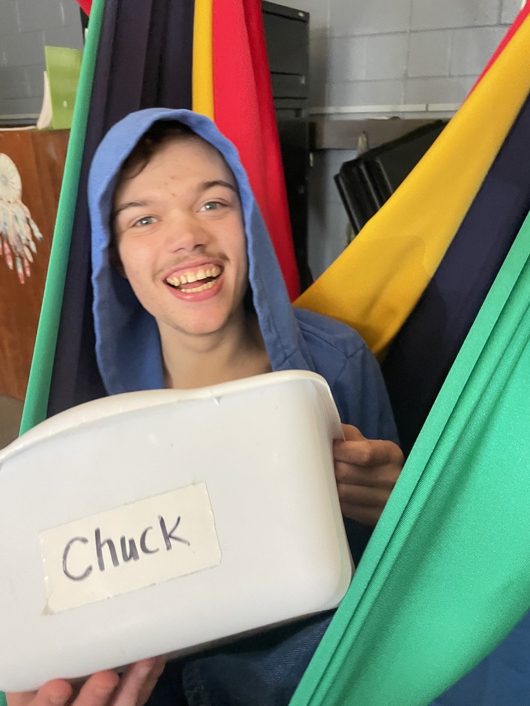 Young man holding a bucket with his name.