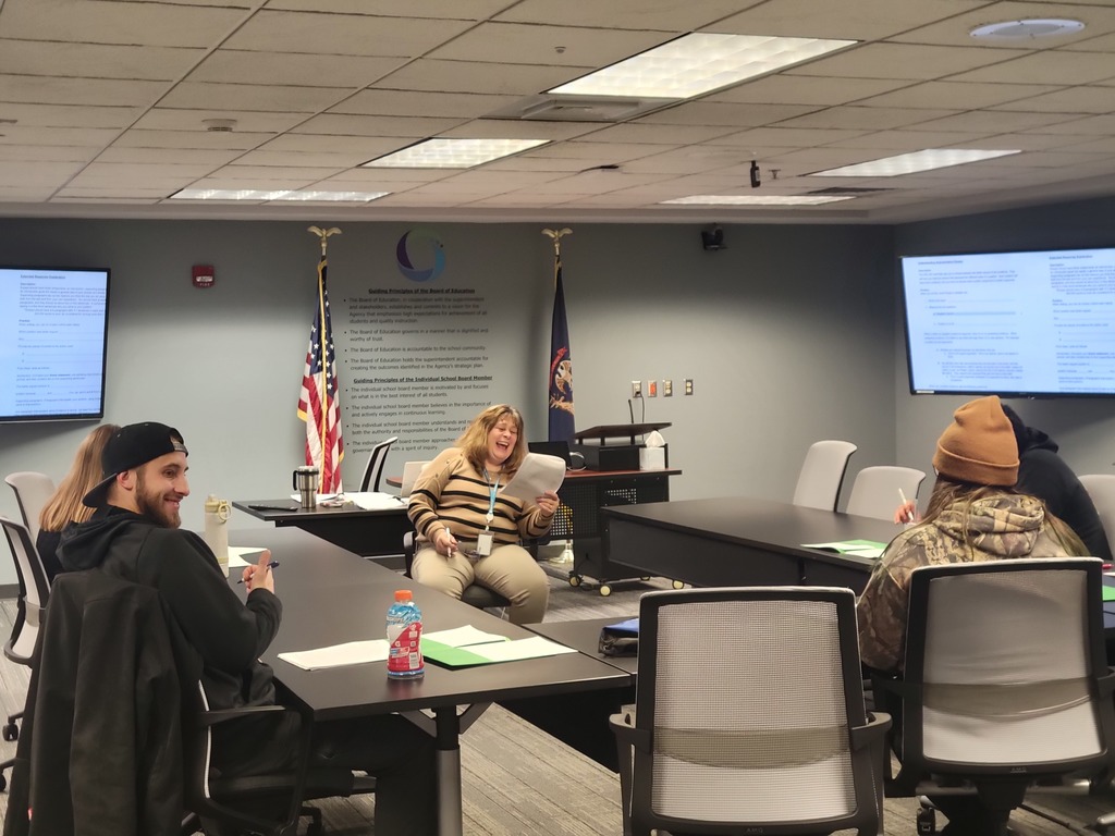 Group of adults in a conference room. 