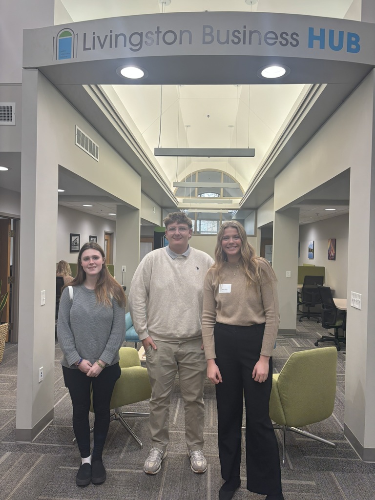 Students standing under the Livingston Business Hub