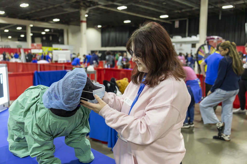 WAY student examining a furry friend