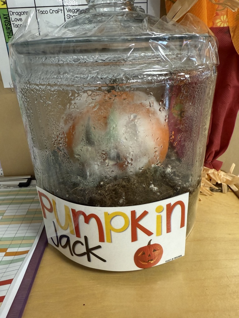A clear glass jar labeled “Pumpkin Jack” sits on a classroom table