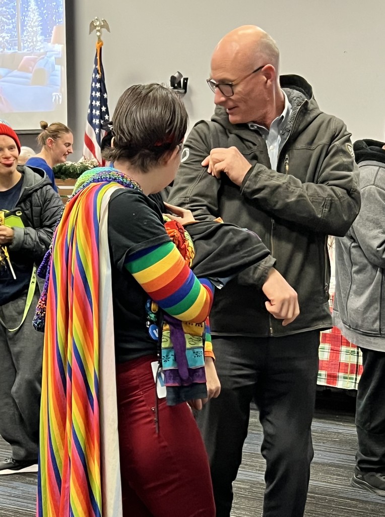 Two people talking in large room