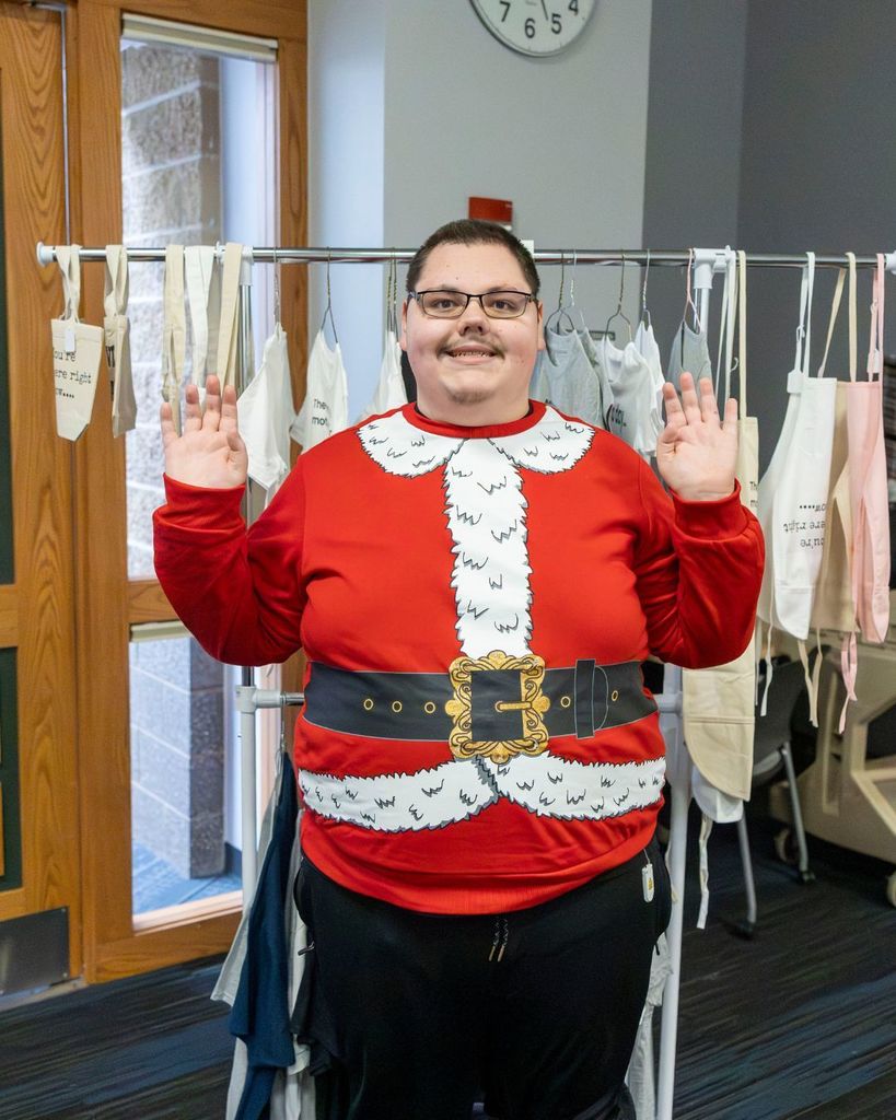 Student selling aprons and tote bags