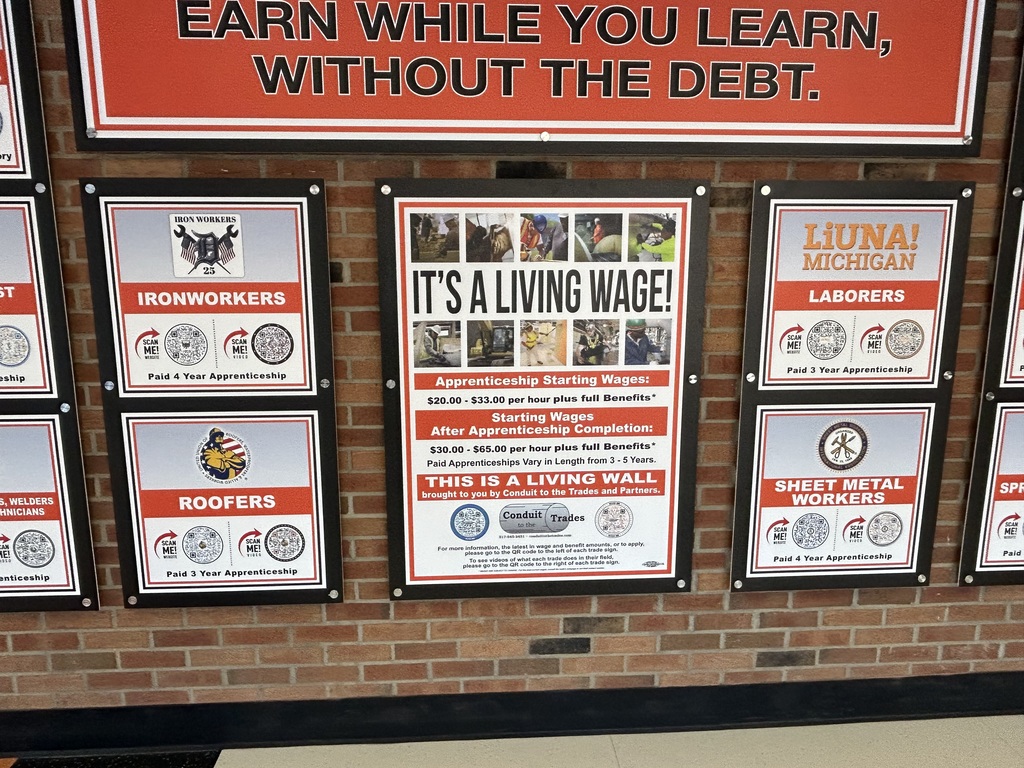 Brick wall with information about various apprenticeships 
