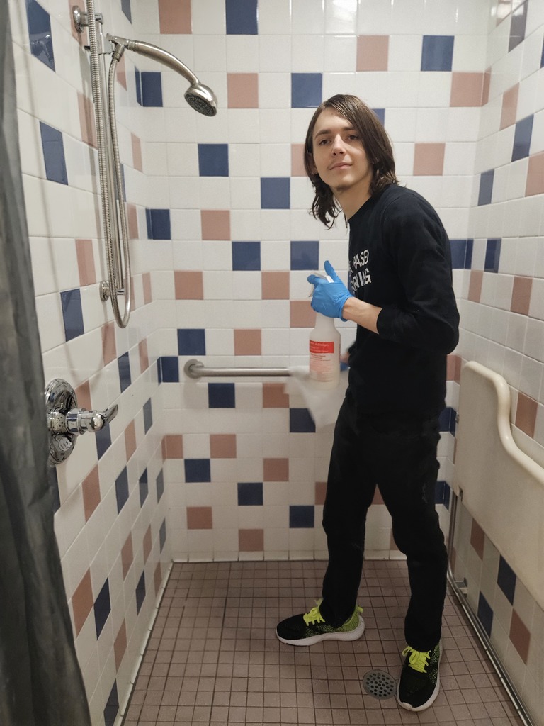 Student cleaning the shower