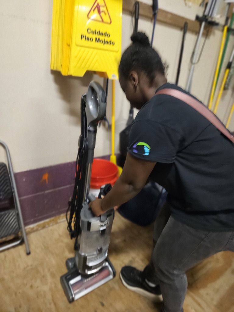 Student emptying the vacuum