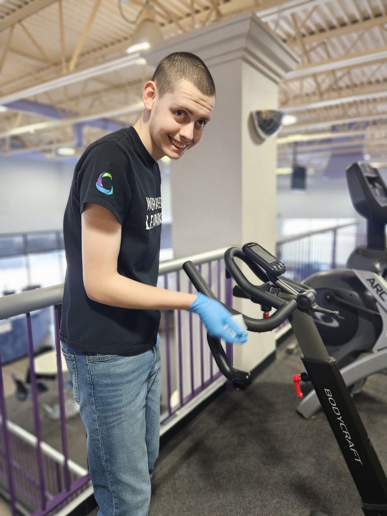 Man cleaning exercise equipment 