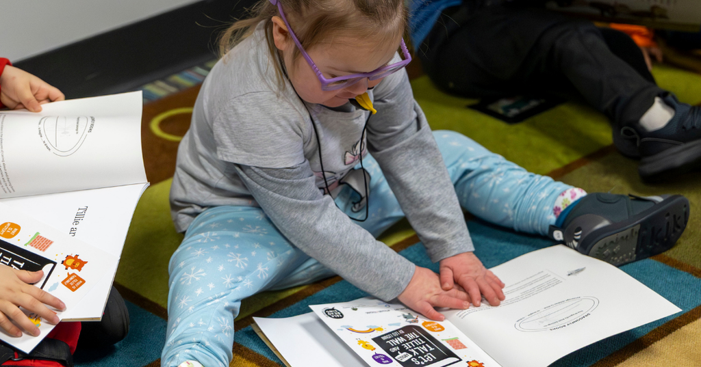 Young girl reading her new book.