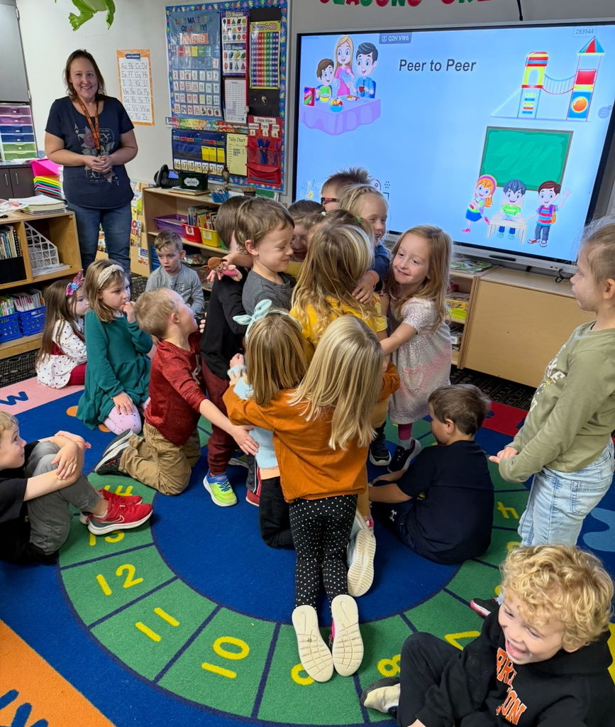 Students engage in a group hug to show support to a classmate