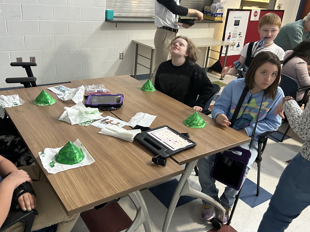 students painting a Christmas tree