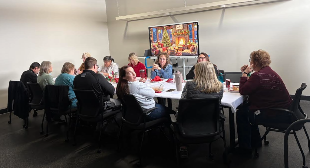 Staff sitting around a table eating lunch.