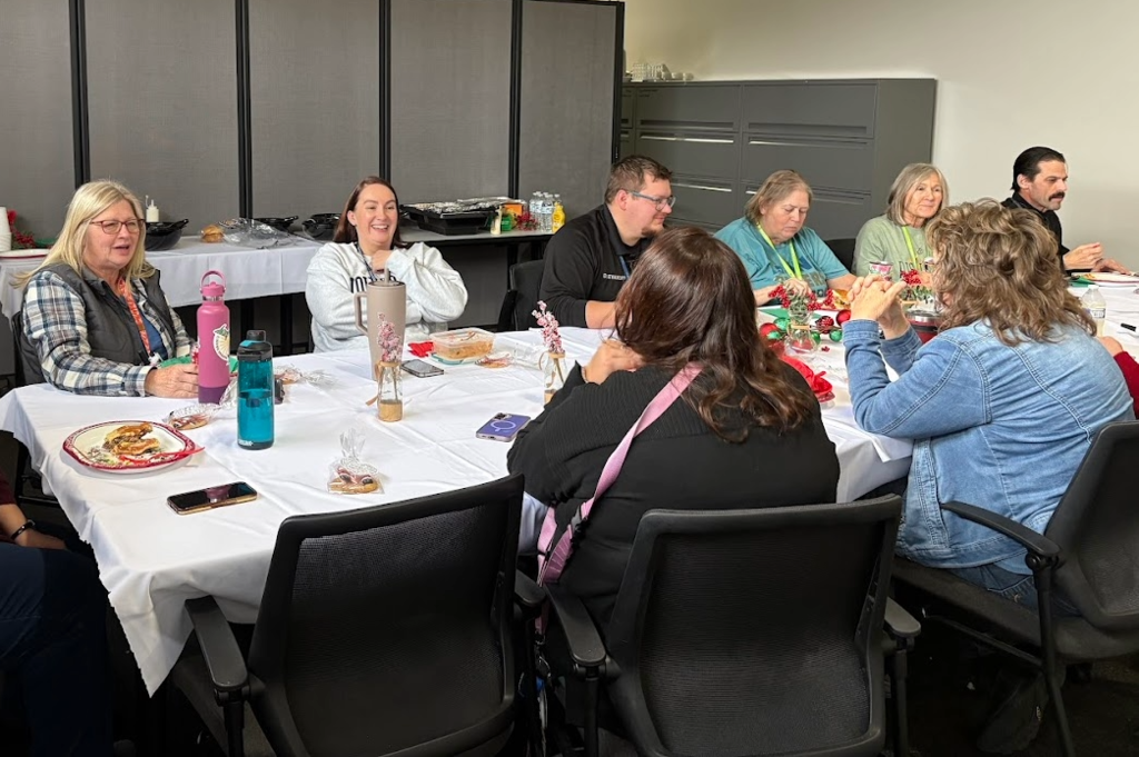 Staff sitting around a table eating lunch.