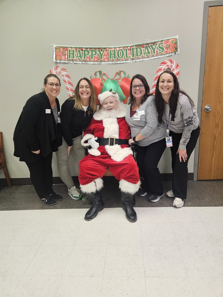 Santa sitting in the middle of 4 ladies