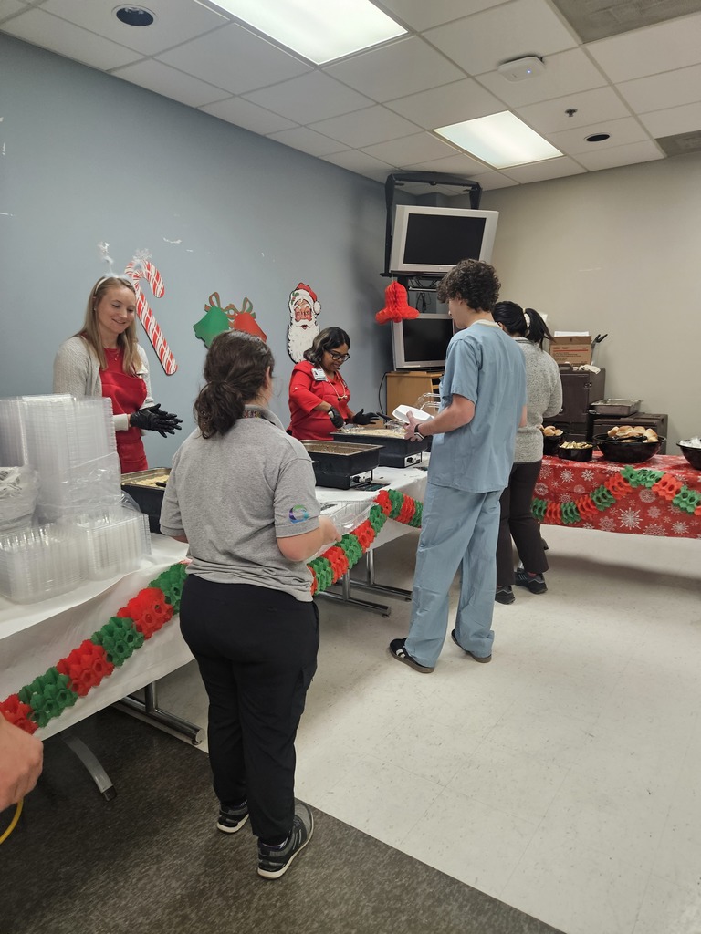 People in a line being served food