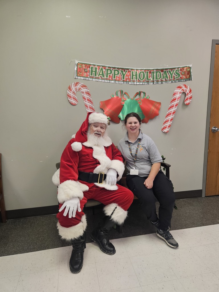 Santa with a young lady sitting next to him
