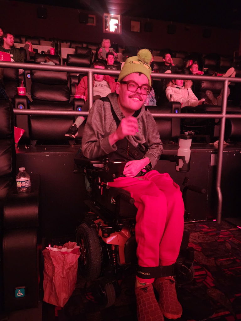 Learners sitting inside a movie theater.