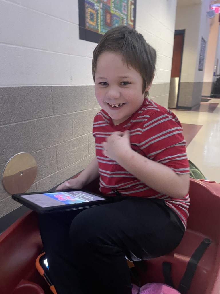 Young learner getting a ride in a wagon.