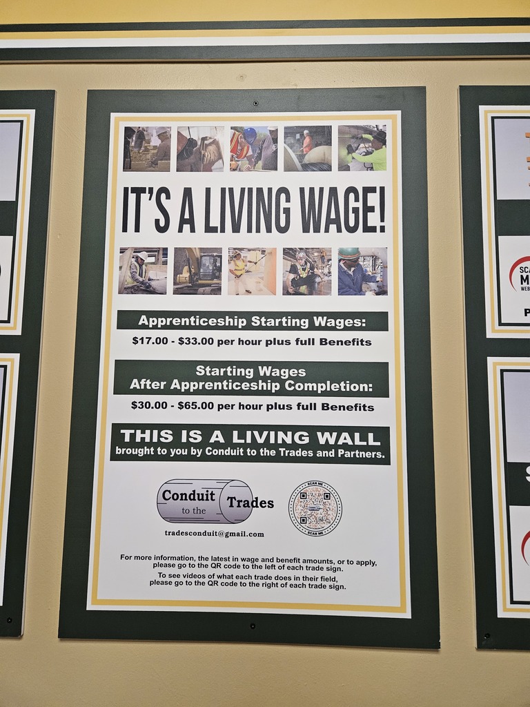 sign on wall that says its a living wage with information about apprenticeship programs