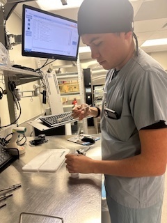Man in scrubs  with  medical tools.