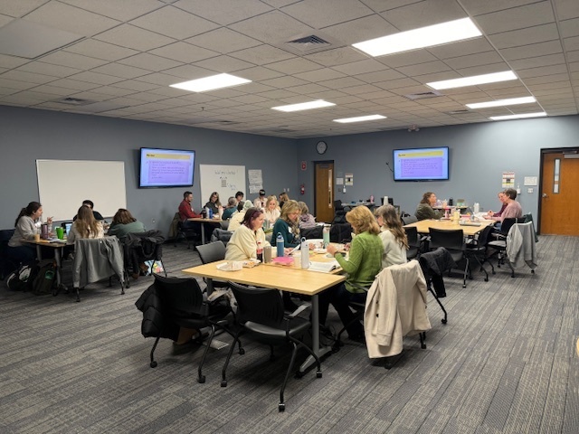 Small groups of instructional coaches talking together and reflecting on what they are learning.