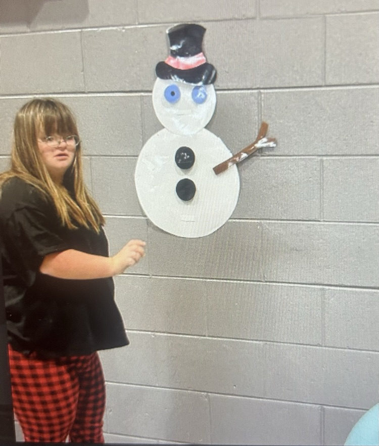 student next to snowman