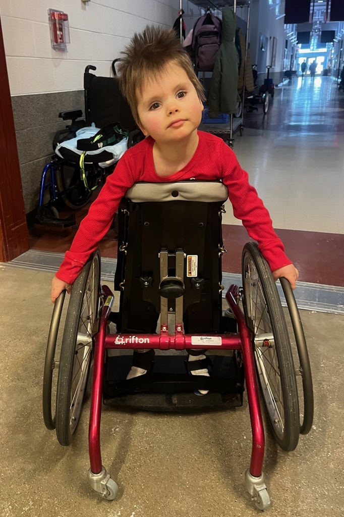 Student in a mobile stander in the hallway.