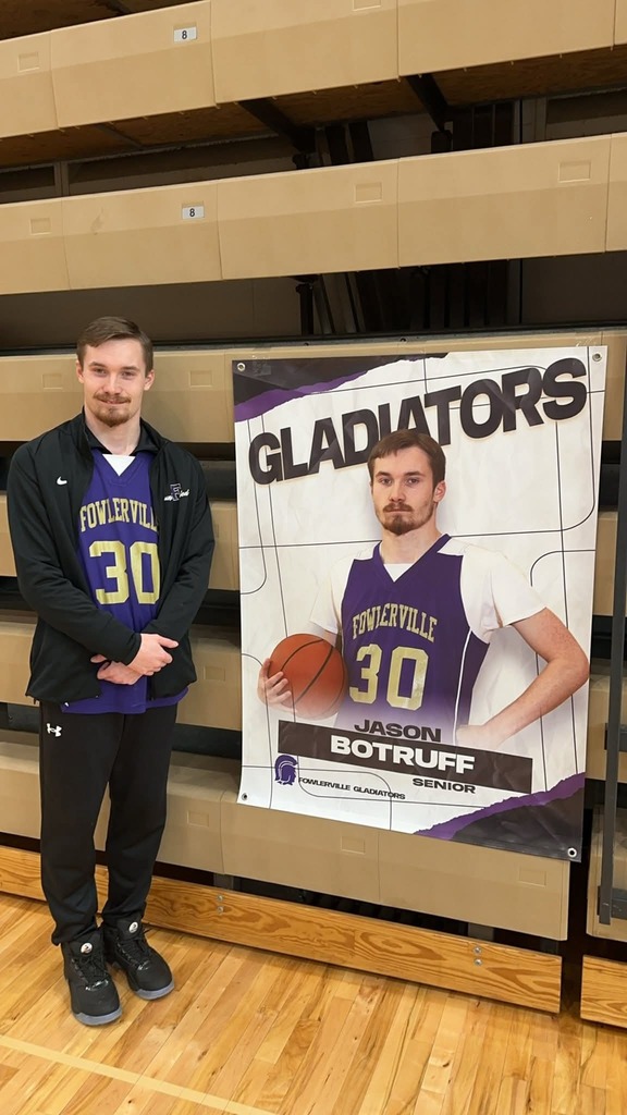 student standing next to basketball photo