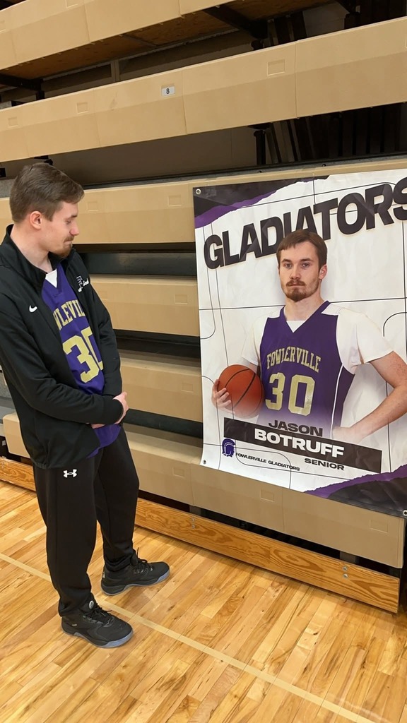 Student looking at his basketball poster