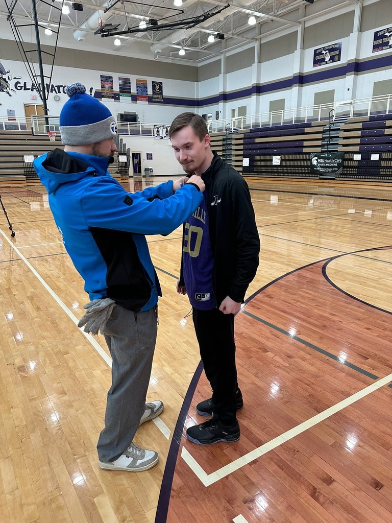 Student getting microphone put on him for an interview