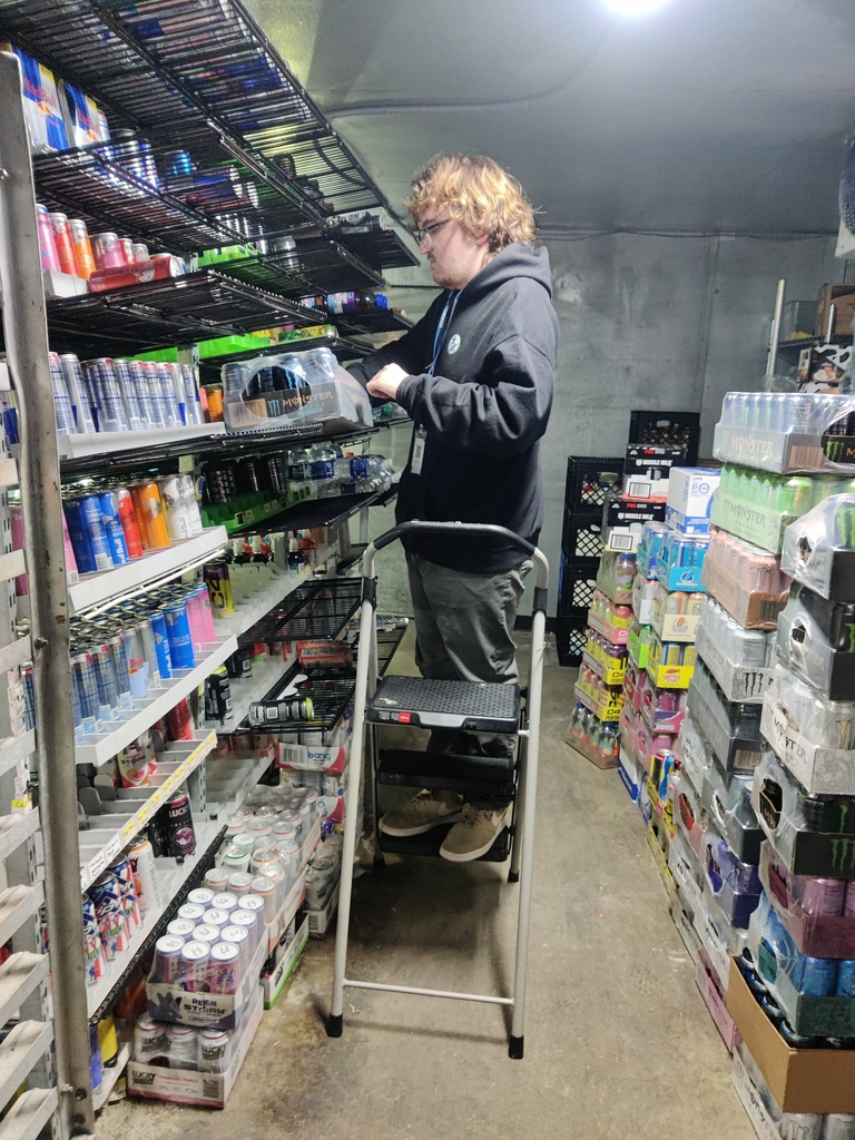 person stocking shelves in walk in cooler 