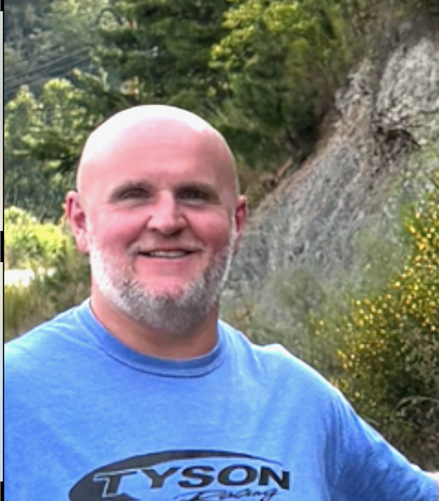 Man next to a hill on a hike 