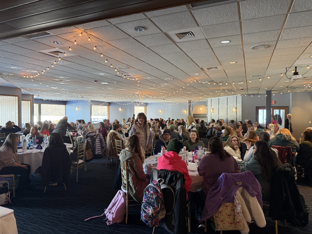 Large group of GSRP teachers seated at round tables in a conference room, engaged in discussion and collaboration during an NCPMI professional learning session.
