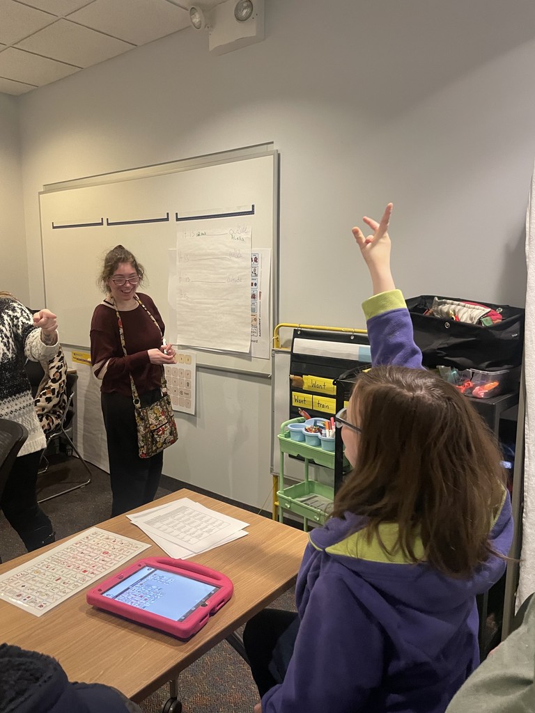 Student raising hand to interaction with another students.